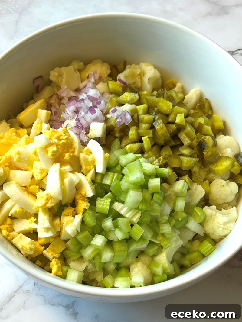 Roasted Cauliflower and Potato Salad with Herb Vinaigrette 5 Cooked cauliflower with celery, pickles, hard boiled eggs, and red onion.