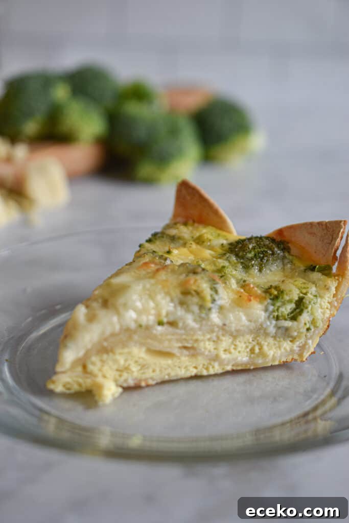 slice of broccoli cheddar quiche with tortilla crust
