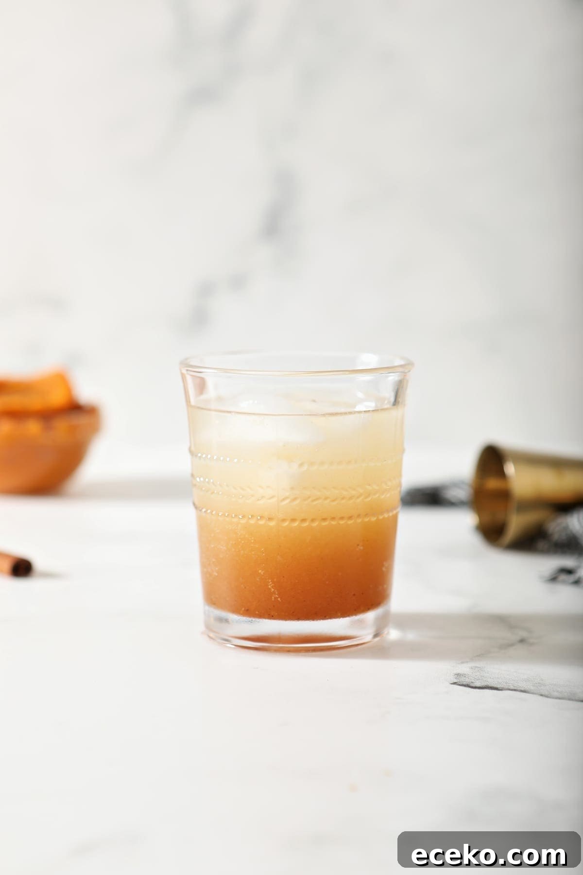 A glass of Pumpkin Spice Moscow Mule on marble, before garnishes are added