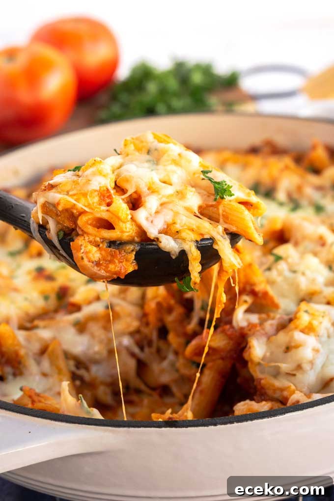 Chicken Parmesan Pasta with Crispy Chicken and Marinara 3 Serving a scoop of cheesy Chicken Parmesan Pasta.