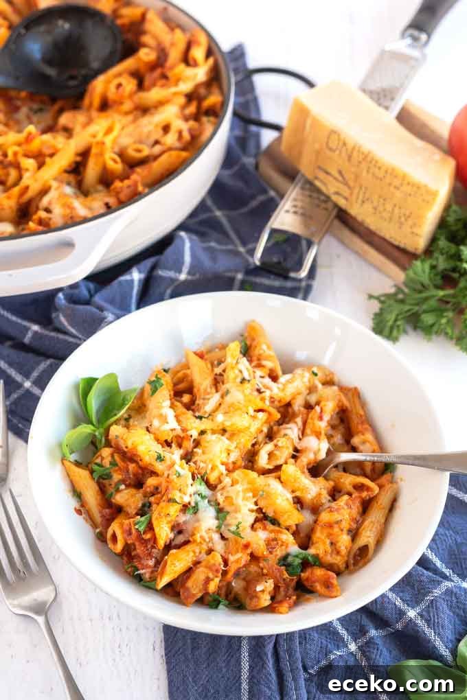 Chicken Parmesan Pasta with Crispy Chicken and Marinara 4 A white bowl filled with Parmesan Pasta with chicken
