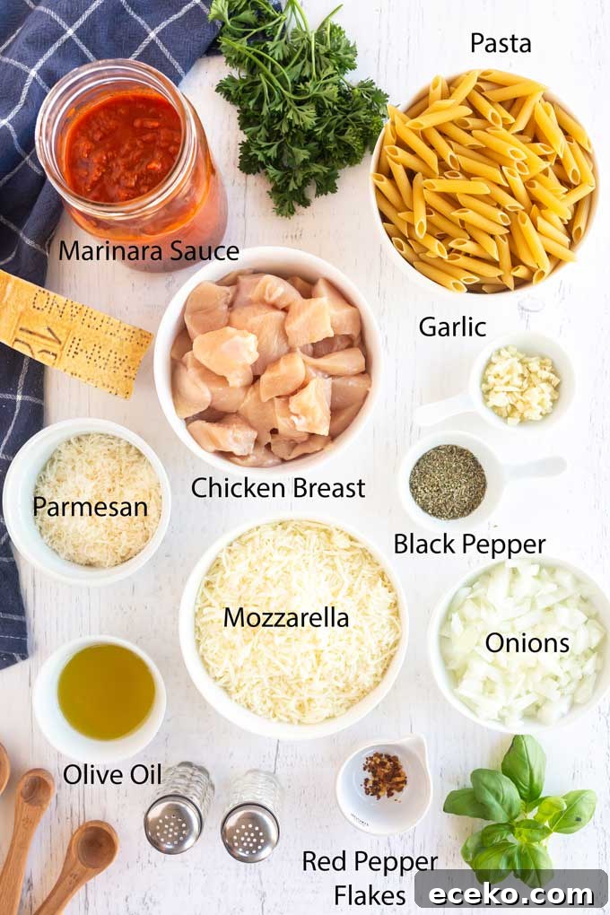 Chicken Parmesan Pasta with Crispy Chicken and Marinara 5 Ingredients to make Chicken Parmesan Pasta on a white wooden surface.