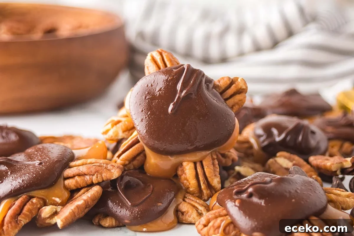 How to Make Classic Homemade Turtle Candies at Home 2 A pile of homemade turtles—chocolate-covered pecans with caramel—sits enticingly amidst loose pecans on a white surface. In the background, a wooden bowl and striped cloth add rustic charm.