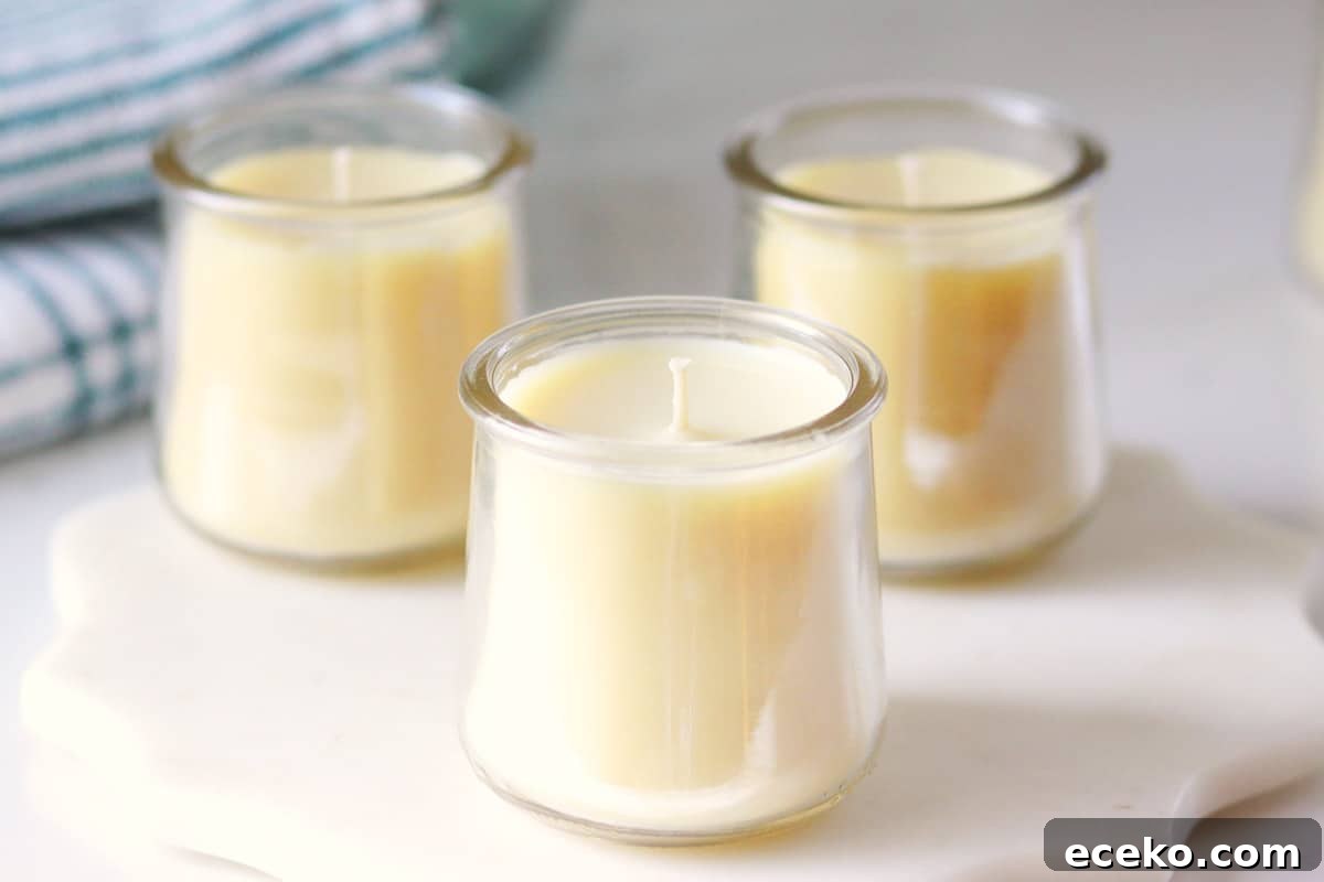 three beeswax candles in oui yogurt jars