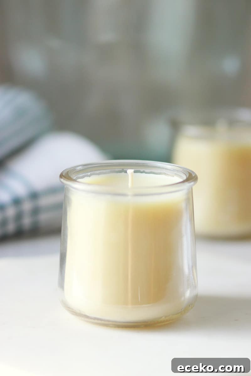 a beeswax candle made in a oui yogurt jar