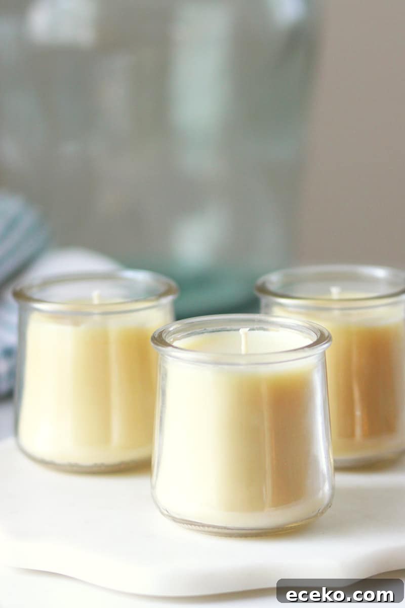 three beeswax candles in oui yogurt jars