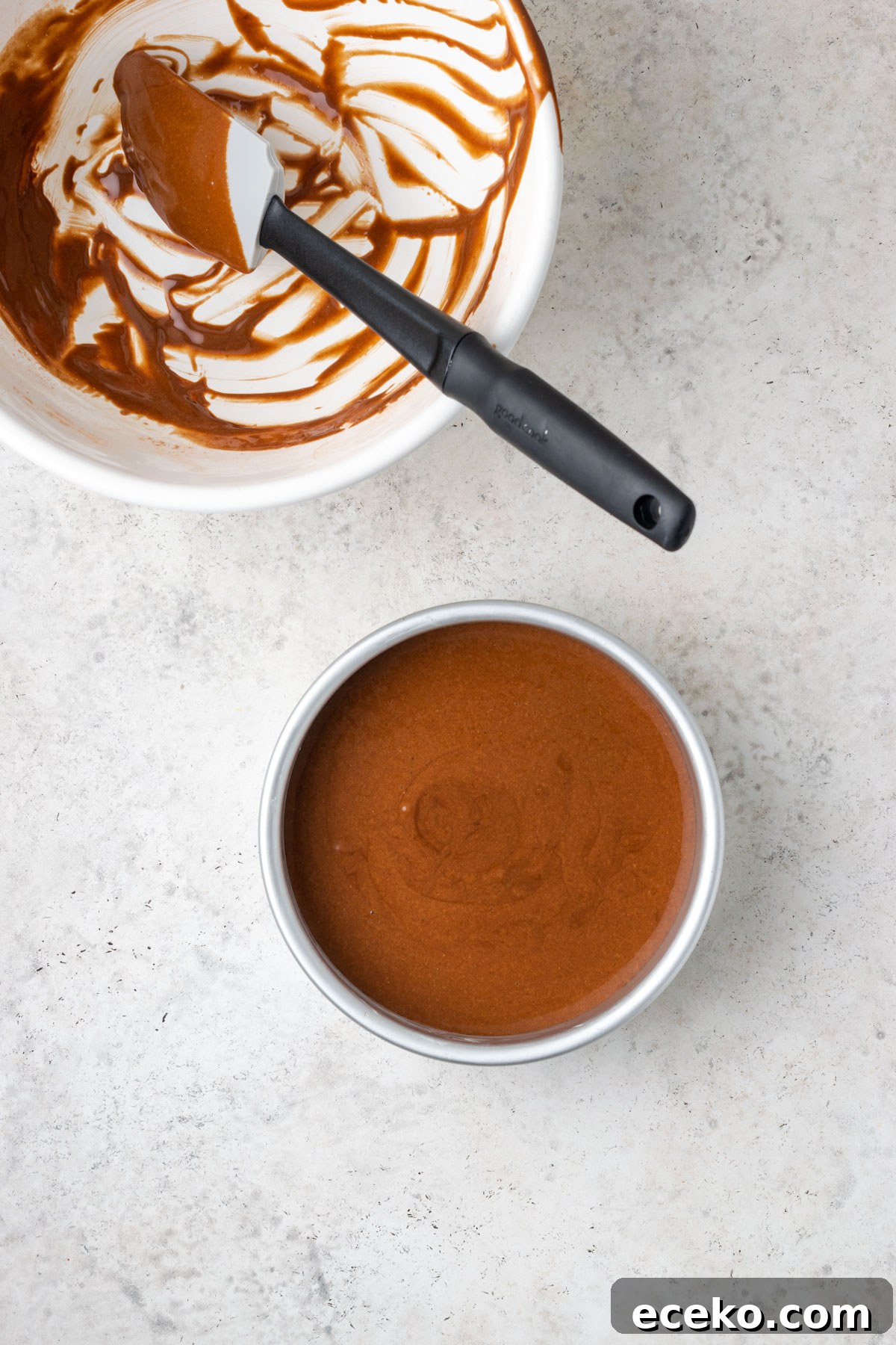 Unbaked chocolate cake batter in a small 6-inch cake pan.