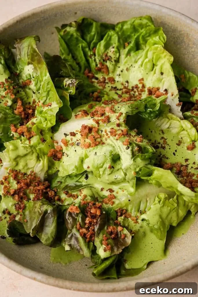 Close up view of green goddess salad topped with feta cheese and breadcrumbs.