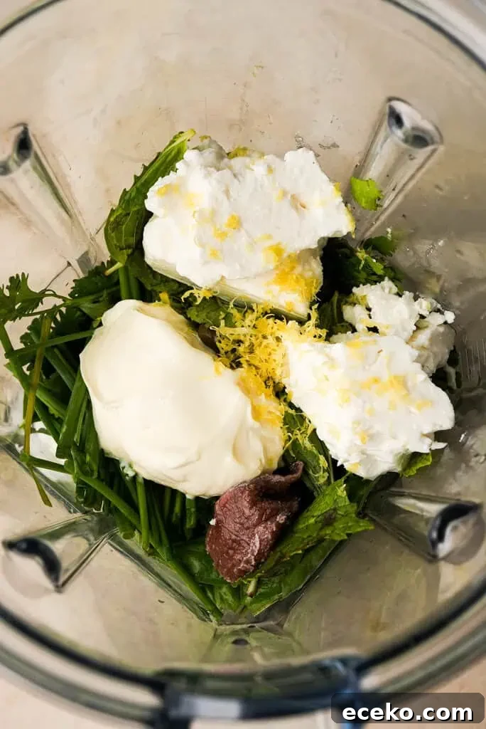 Ingredients for green goddess salad dressing in a blender.