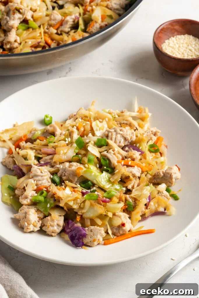 45 degree angle shot of a white pasta bowl filled with a serving of turkey egg roll in a bowl.