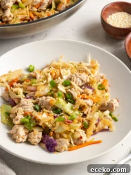 45 degree angle shot of a white pasta bowl filled with a serving of turkey egg roll in a bowl.