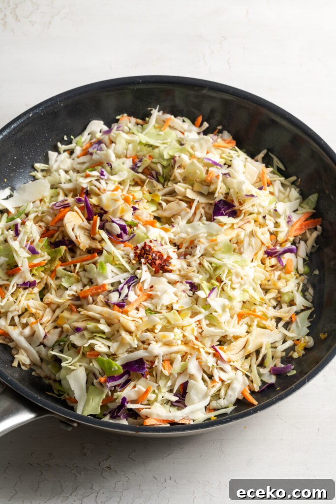 coleslaw mix added to the skillet to saute with the aromatics.