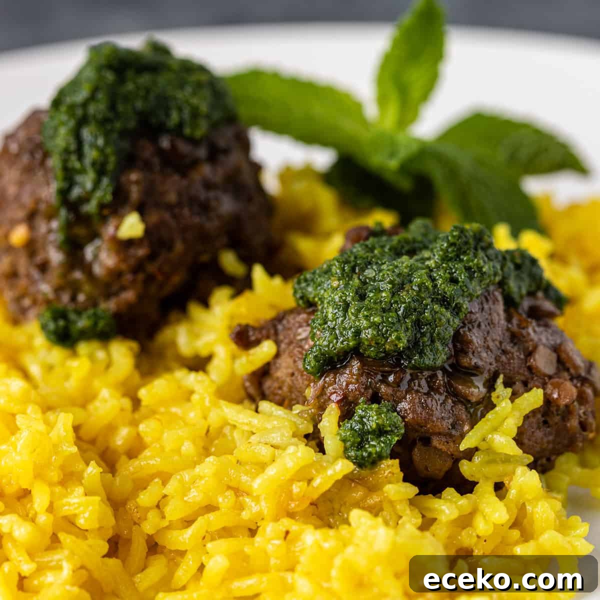 Savory Lamb and Lentil Meatballs with Zesty Lemon Rice 2 closeup side view: lamb and lentil meatballs over lemon rice with fresh mint and pesto