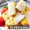 Keto Air Fryer Strawberry Cheesecake Roll Ups on a plate with strawberries