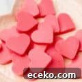 close up of keto strawberry heart-shaped gummies on a plate