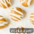 close up of high protein cinnamon roll energy bites with cream cheese icing