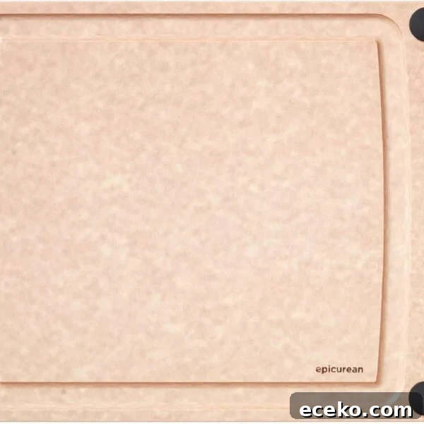 A rectangular, light brown cutting board with a smooth surface, four black non-slip corners, and a small hole on the left side.