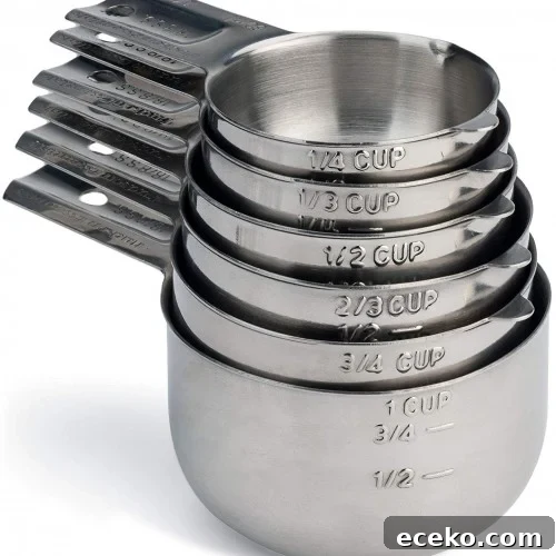 A nested stack of stainless steel measuring cups