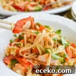 peanut noodles in bowl with chopsticks