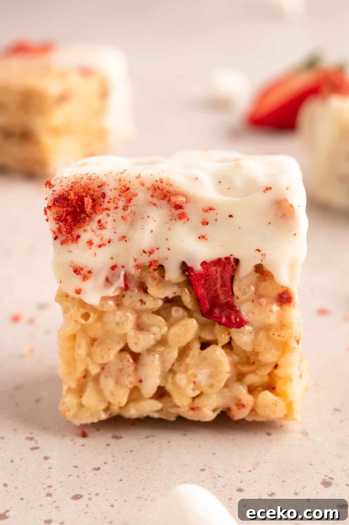 Strawberry Rice Krispie Treats Recipe for Fresh, Fruity Squares 10 closeup of a Strawberry Rice Krispie Treat dipped in white chocolate