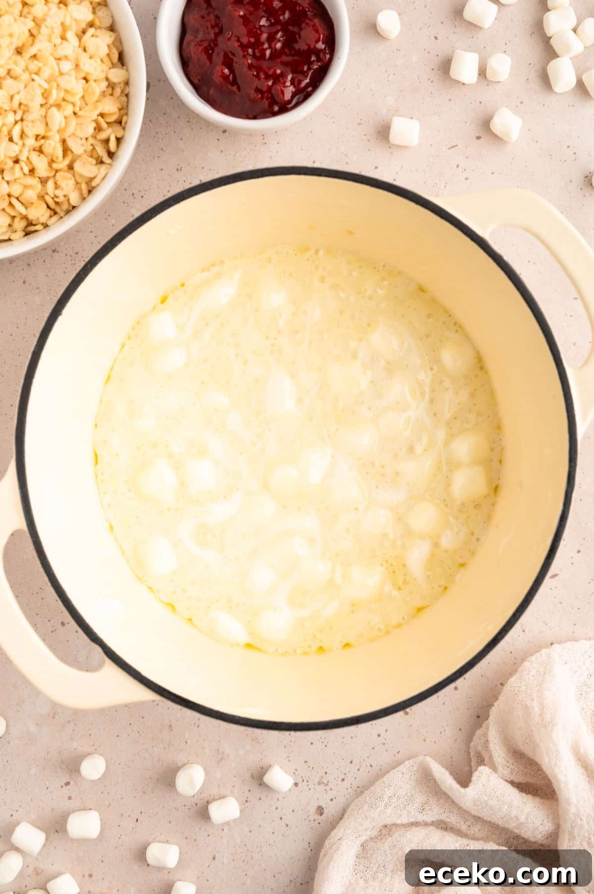 Strawberry Rice Krispie Treats Recipe for Fresh, Fruity Squares 4 overhead photo of marshmallows melting in butter in a white enameled cast iron pot