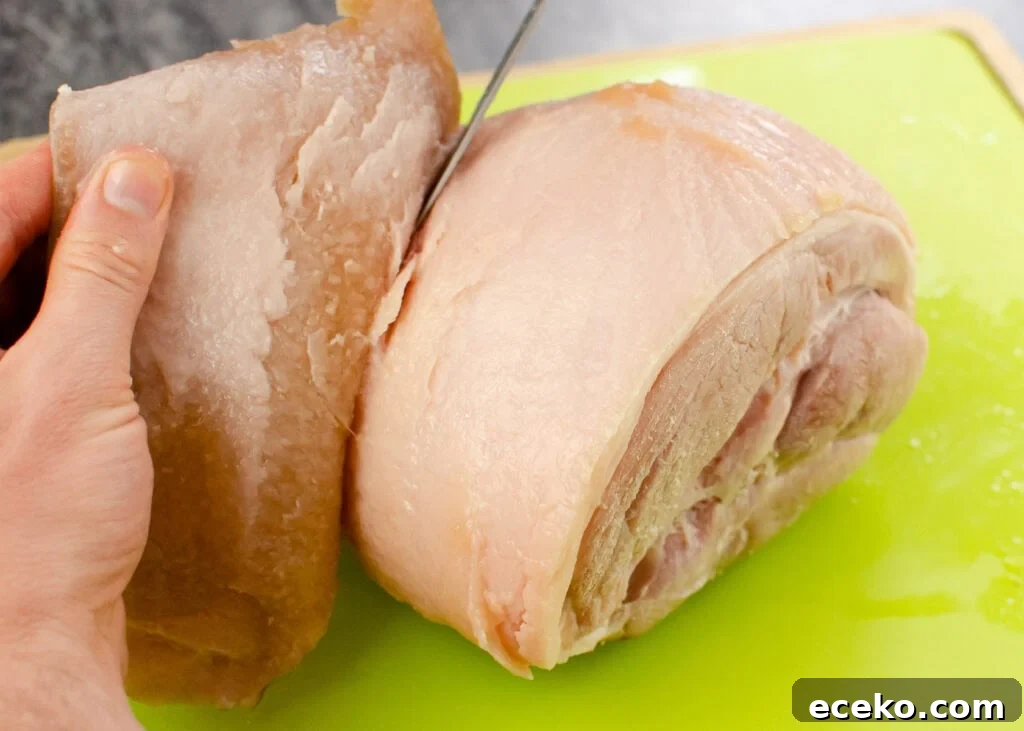 Honey-Glazed Roast Gammon Joint Recipe 18 Cutting the skin of the gammon joint with a silver knife