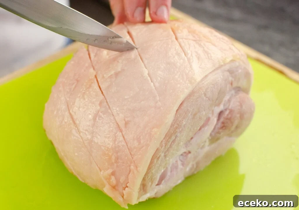 Honey-Glazed Roast Gammon Joint Recipe 19 Scoring criss cross pattern on the fat of the ham joint with a silver knife