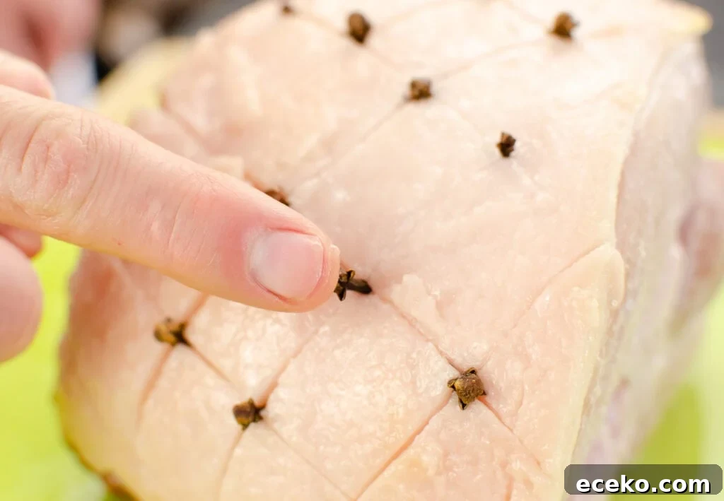 Honey-Glazed Roast Gammon Joint Recipe 20 Pushing cloves into the fat of the gammon joint with fingers