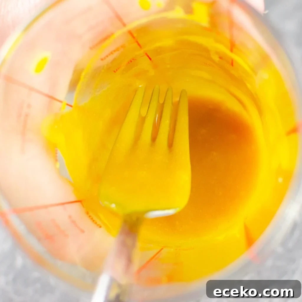Honey-Glazed Roast Gammon Joint Recipe 23 Mixing the honey and mustard together with a silver fork