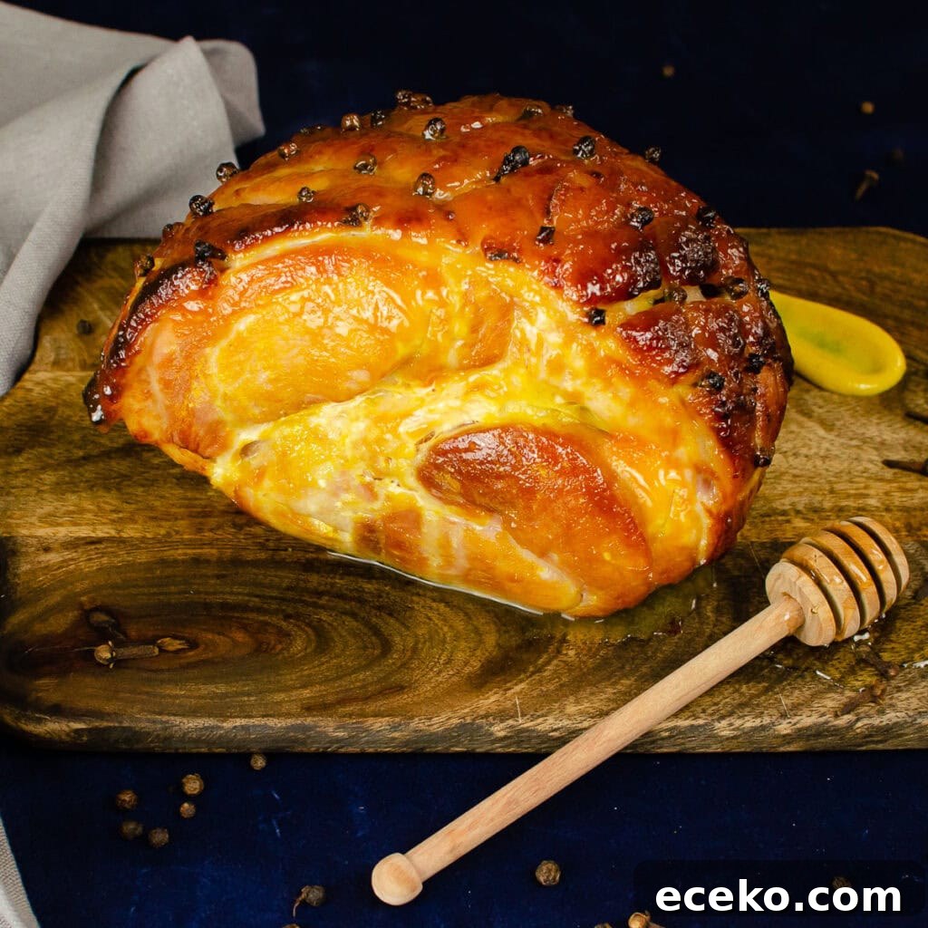Honey-Glazed Roast Gammon Joint Recipe 26 Honey Roast Gammon on a wooden board with a coated honey stick and a dollop of English mustard on the side