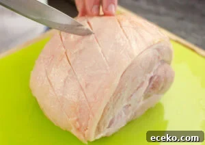Honey-Glazed Roast Gammon Joint Recipe 8 Scoring criss cross pattern on the fat of the ham joint with a silver knife