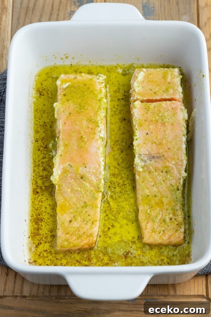 flipping pesto butter salmon to finish baking in the oven