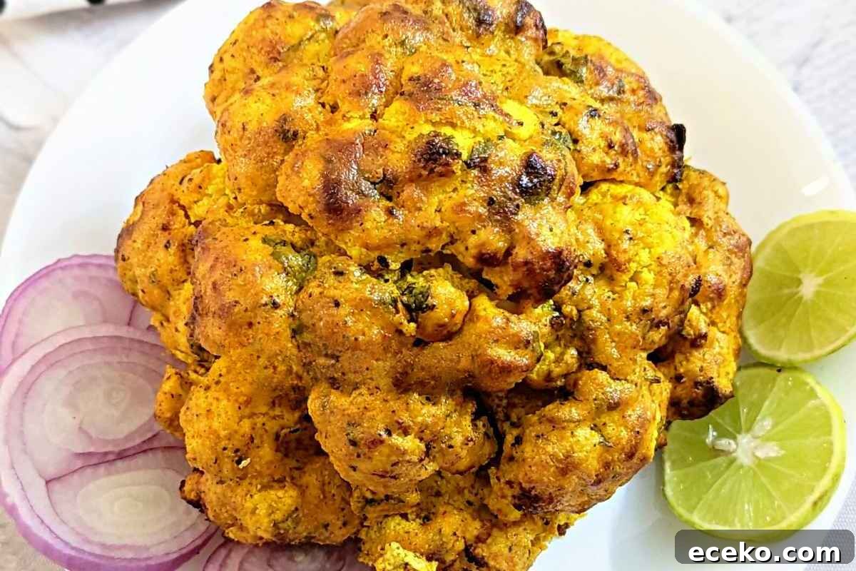 Whole cauliflower served on a white plate