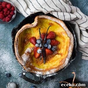 Vanilla Dutch Baby Pancake Recipe: Light Oven-Baked Treat 13 Overhead picture of a vanilla Dutch baby with fruit in the middle.