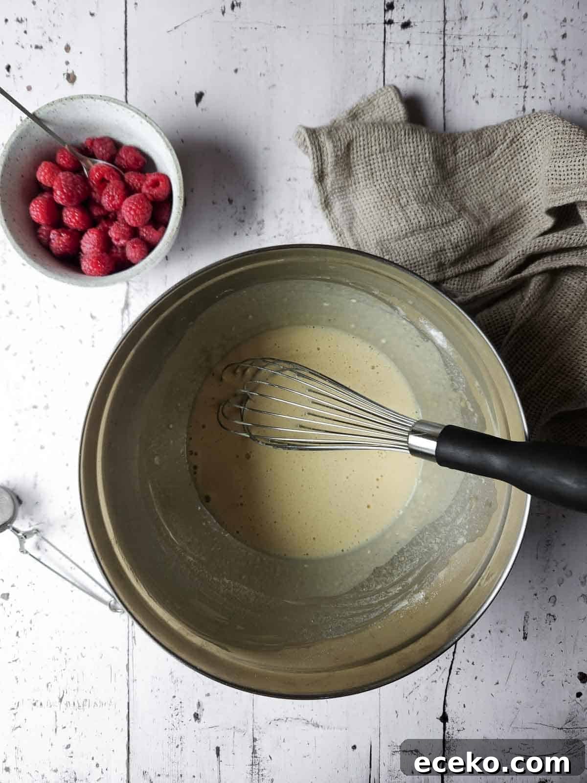 Vanilla Dutch Baby Pancake Recipe: Light Oven-Baked Treat 4 Mixed batter for sweet vanilla Dutch Baby in a metal bowl.