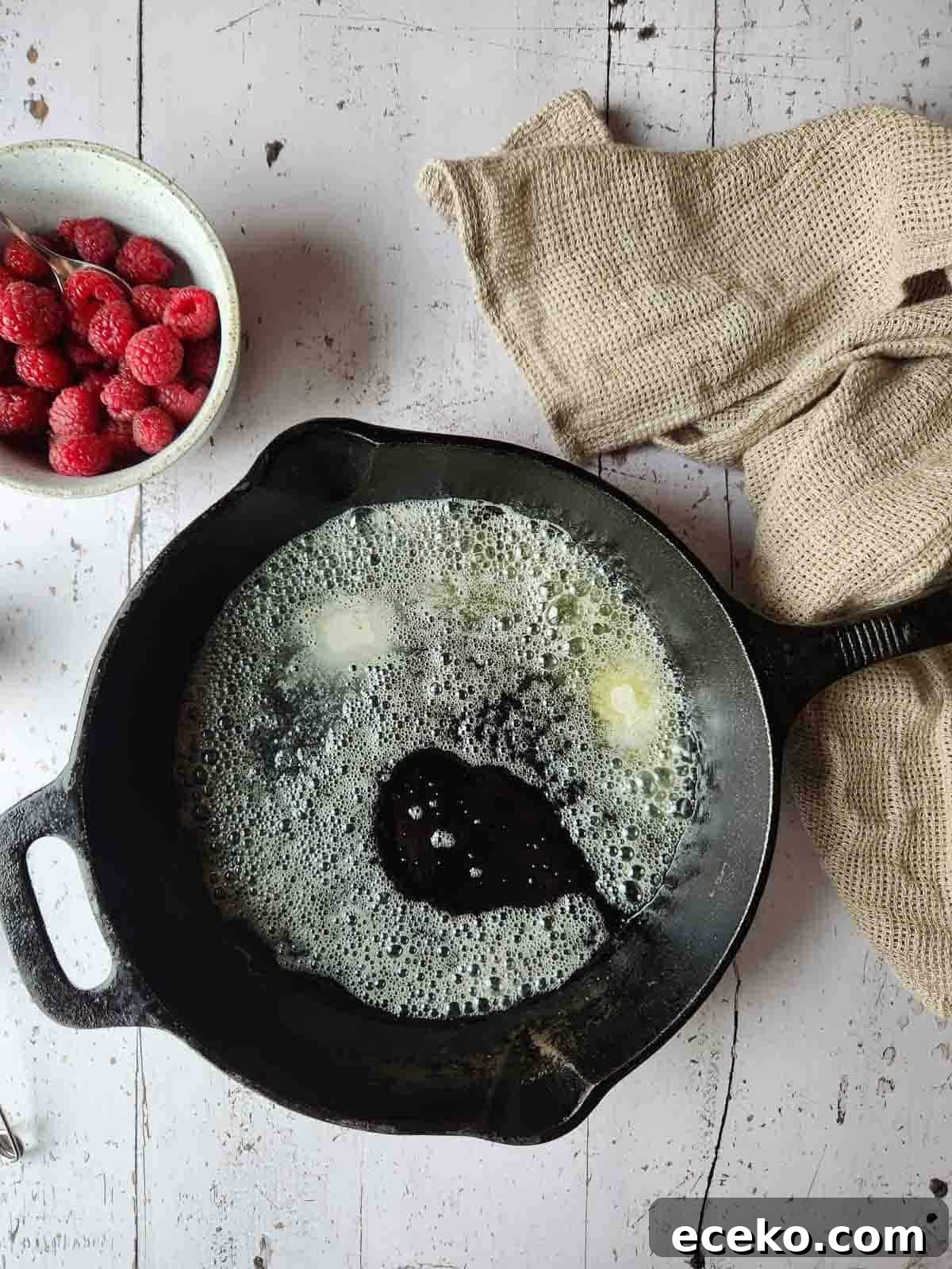 Vanilla Dutch Baby Pancake Recipe: Light Oven-Baked Treat 5 Melted butter prepared in a hot cast iron skillet.