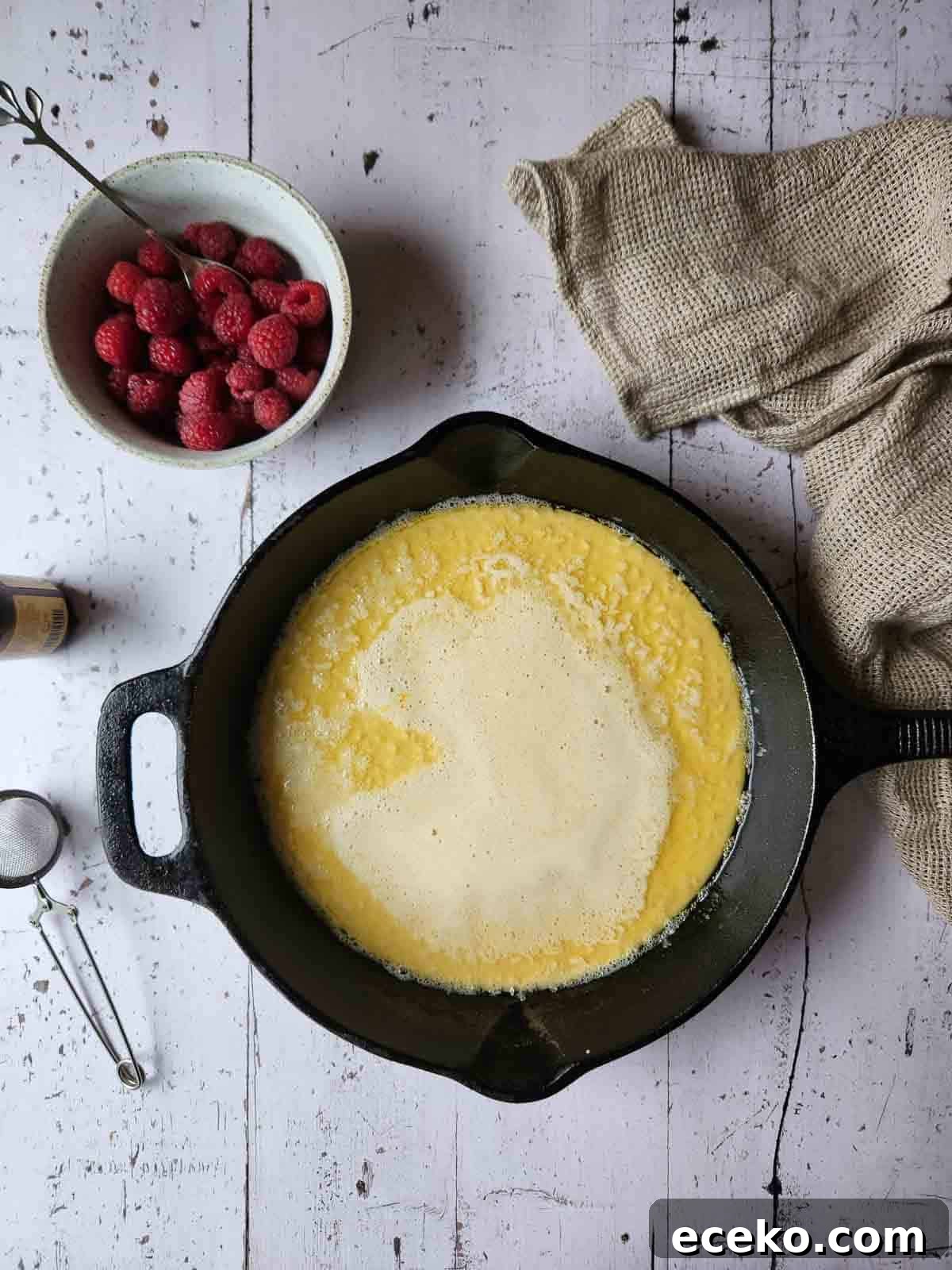 Vanilla Dutch Baby Pancake Recipe: Light Oven-Baked Treat 6 Dutch baby batter poured into a hot cast iron skillet.