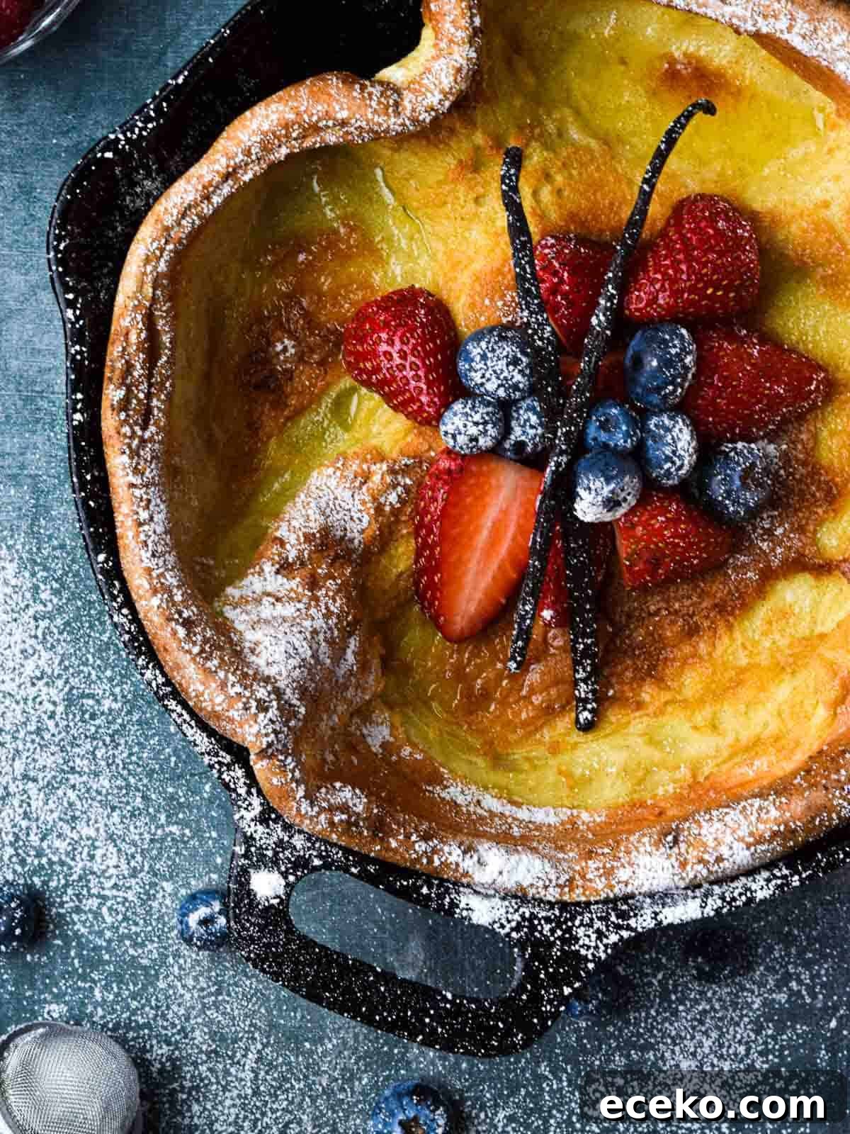 Vanilla Dutch Baby Pancake Recipe: Light Oven-Baked Treat 8 Overhead picture of a vanilla Dutch baby with fruit in the middle.