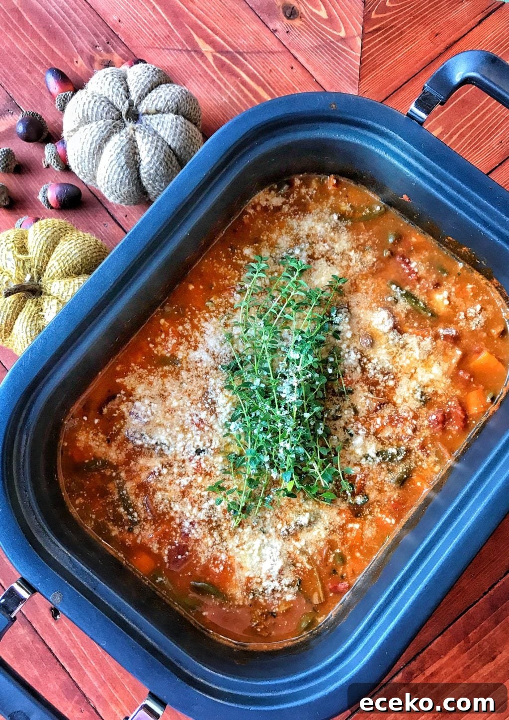Slow-Cooker Minestrone Soup Recipe for Hearty Weeknight Meals 2 A slow cooker with a rich brownish soup broth and vegtables like carrots and beans