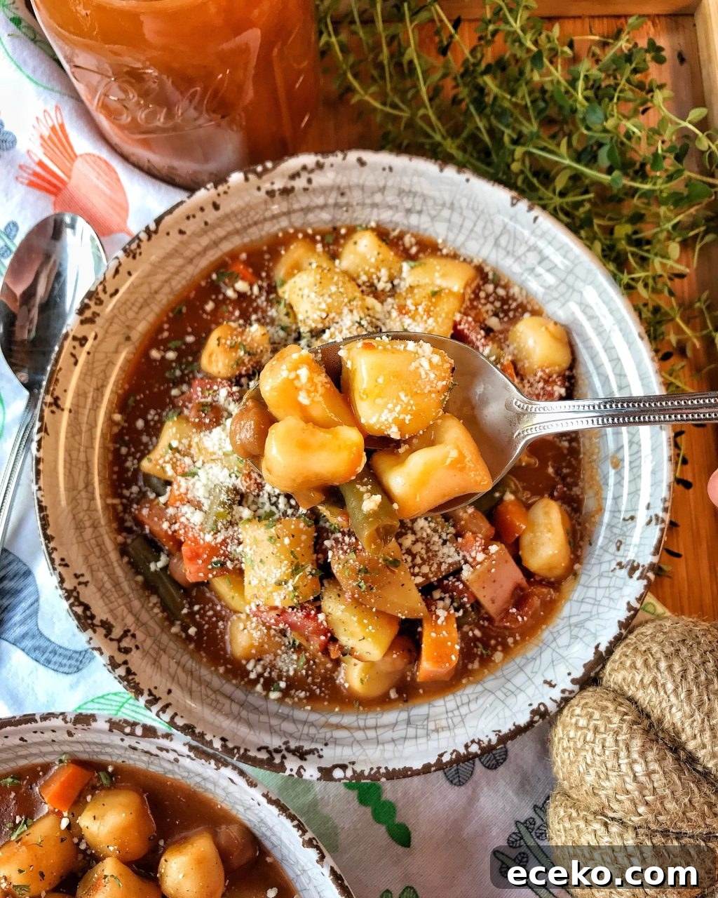 Slow-Cooker Minestrone Soup Recipe for Hearty Weeknight Meals 5 A spoon of mini potato dumplings on a spoon held over a bowl of minestrone soup