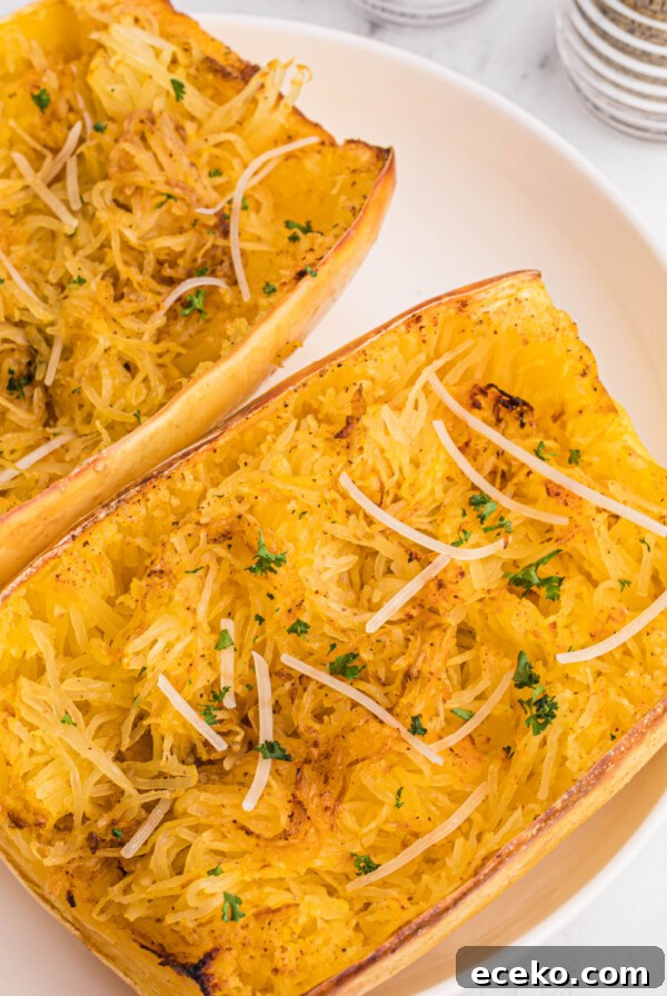 Overhead of spaghetti squash on a white plate, ready to serve.