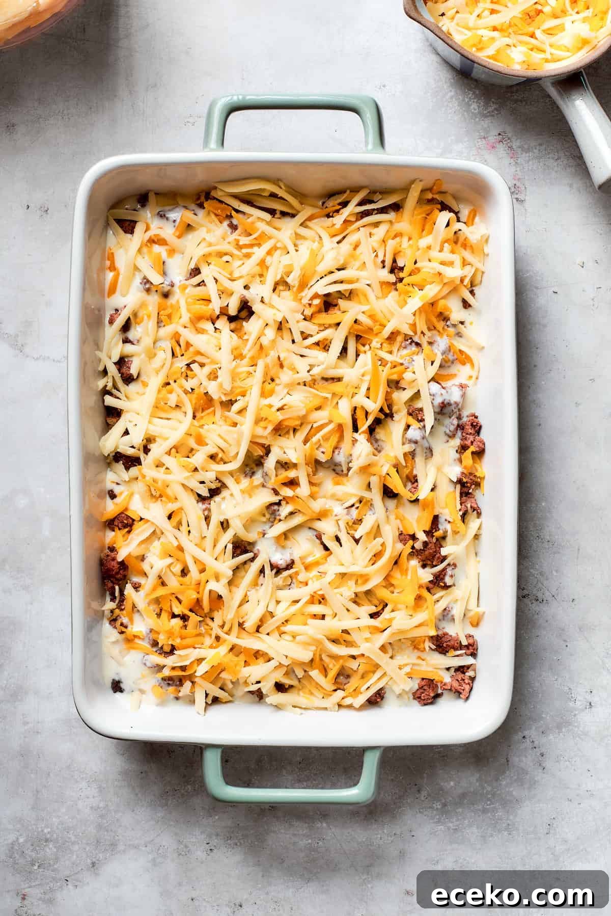 Cheese is added to the meat layer.