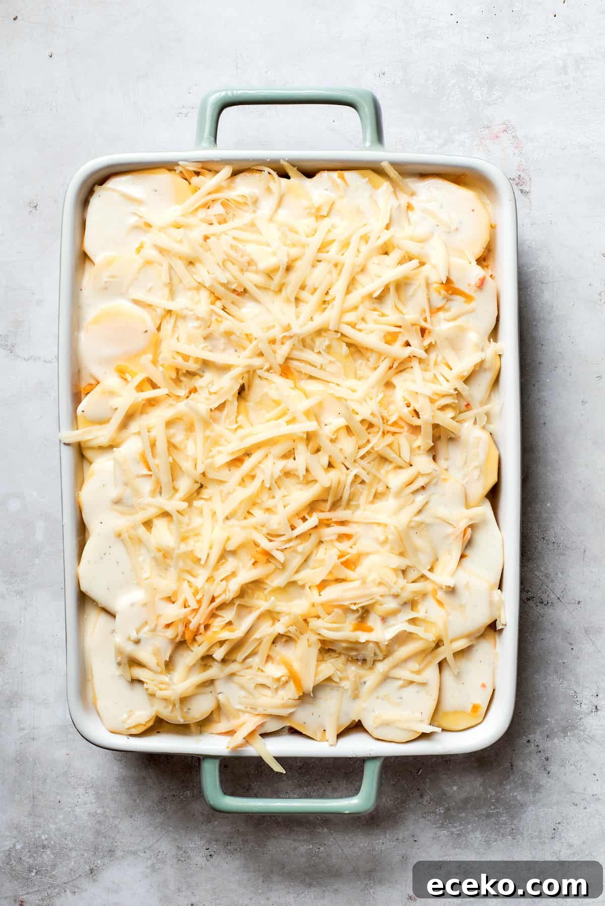 Cheese is added to the top of the casserole,