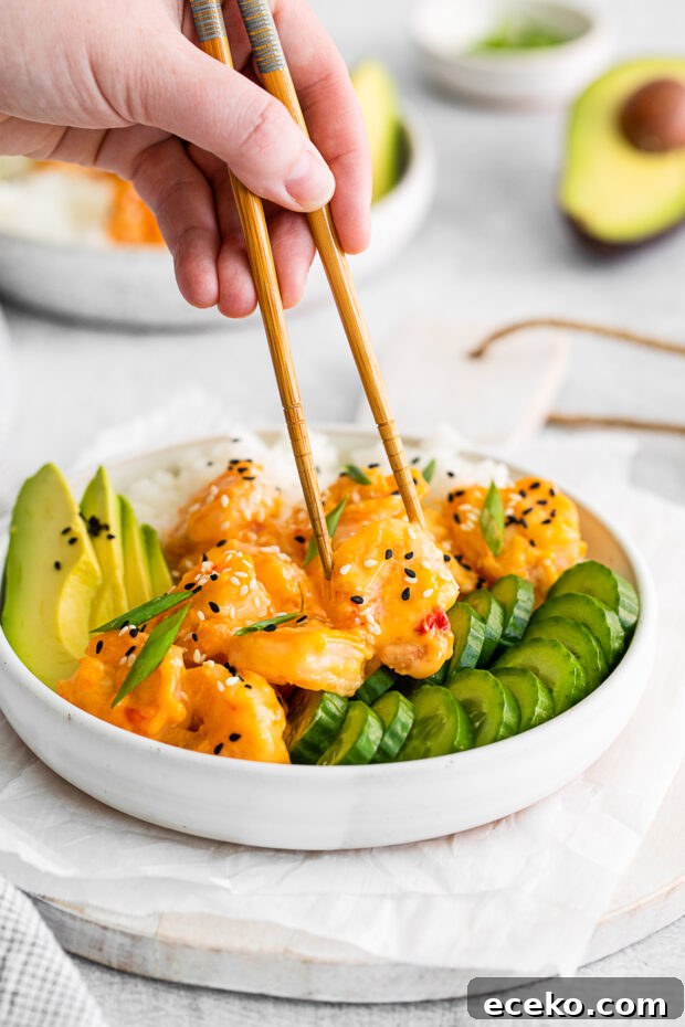Chopsticks picking up a shrimp. 