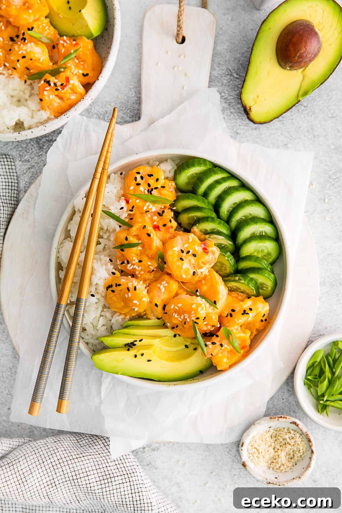 Chop sticks resting on a Bang Bang Shrimp Bowl.