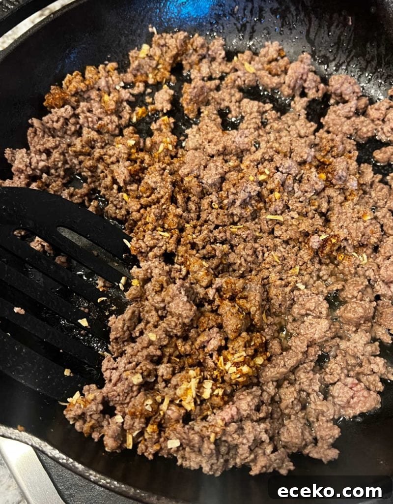 brown ground beef and spices in skillet.