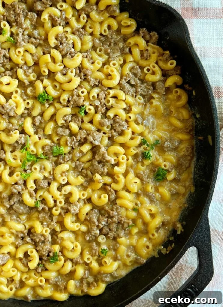 homemade cheeseburger macaroni in skillet with parsley.
