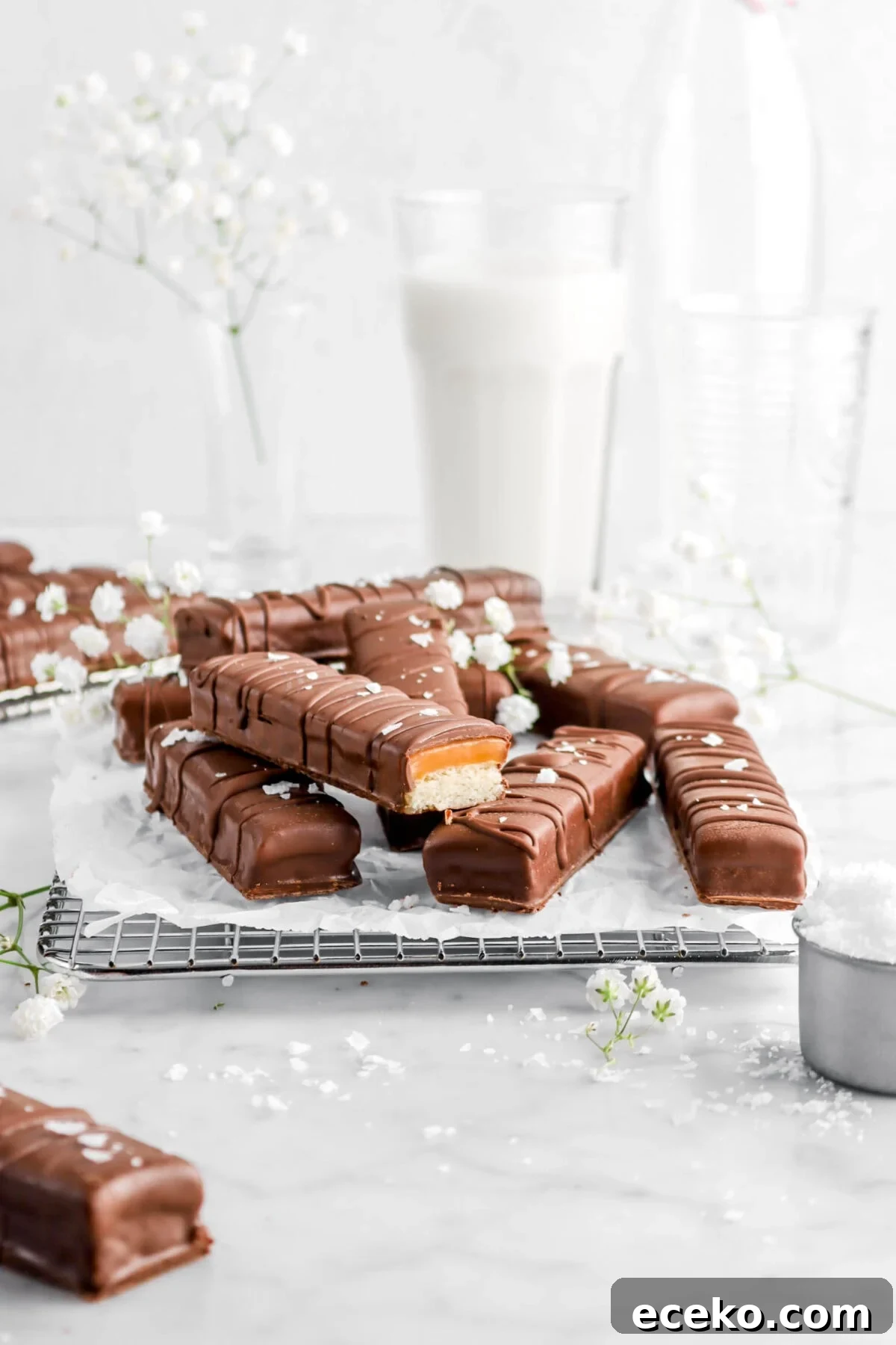 Homemade Twix Bars Recipe: Crispy Caramel Chocolate Cookies 12 twix on wire cooling rack with one cut open