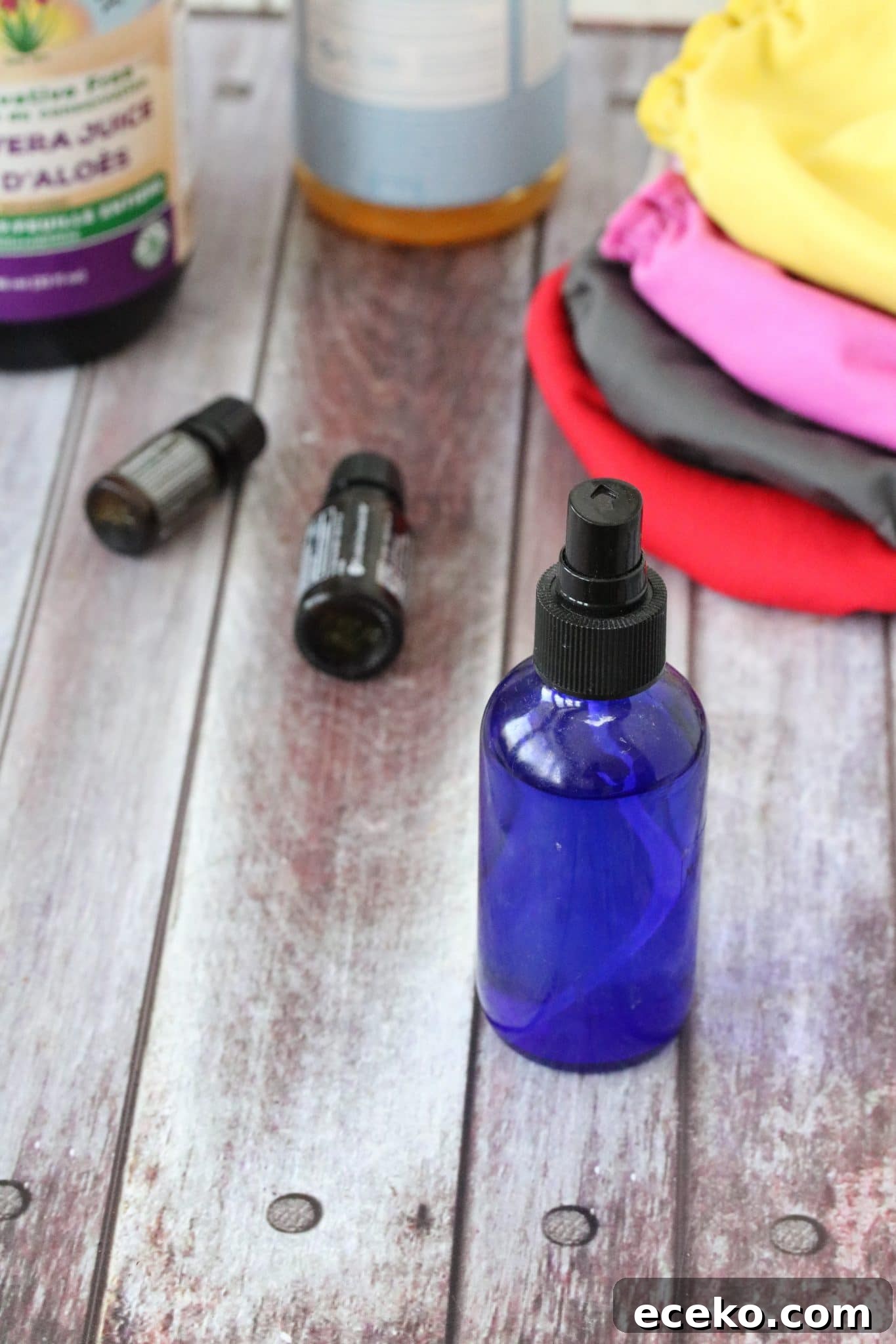 homemade cloth diaper solution in a bottle surrounded by ingredients