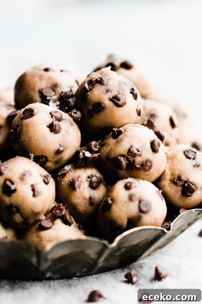 No-Bake Edible Cookie Dough Bites Recipe for Parties 2 Mini no bake cookie dough bites piled in a metal tray.